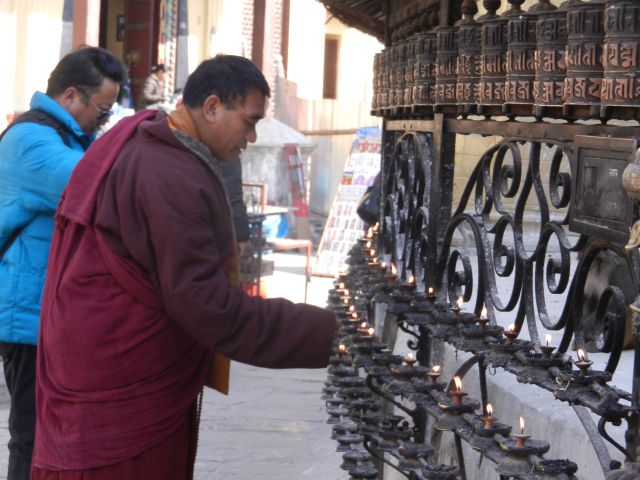 19.Buddhist_munk_with_prayer_wheels_Stupa