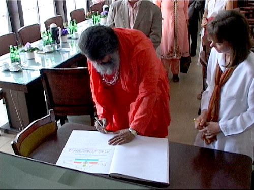 Swamiji signs the Guest Book